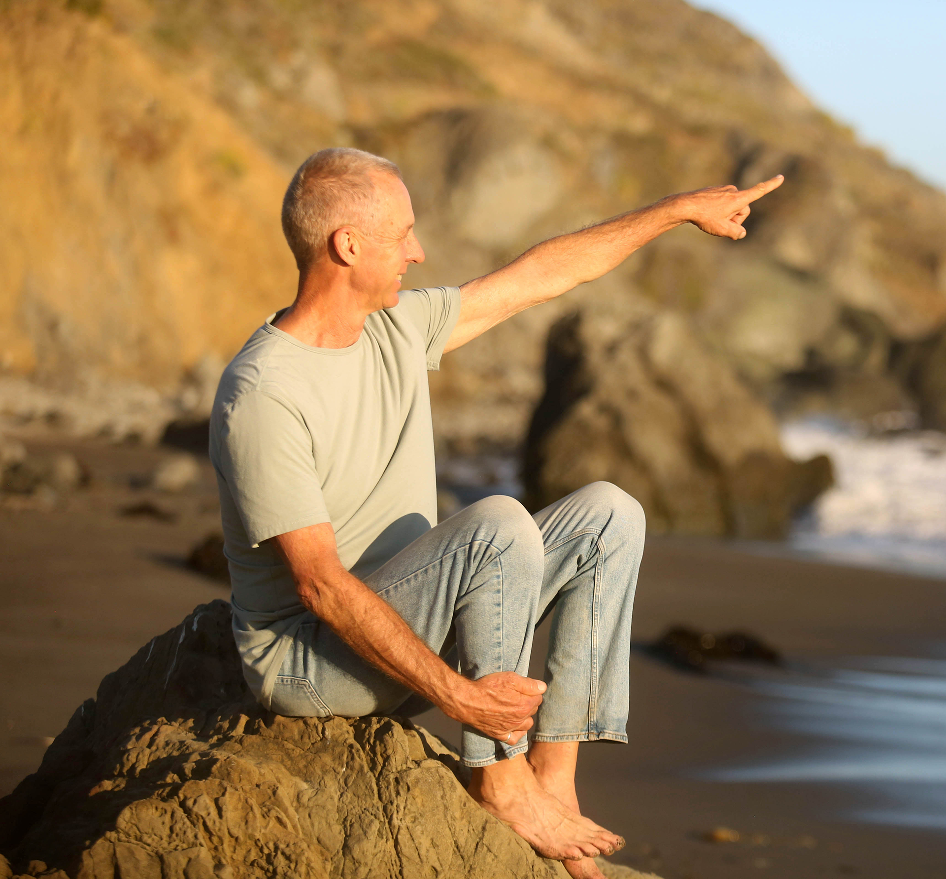 Raven, Spiritual teacher sitting on a rock and pointing